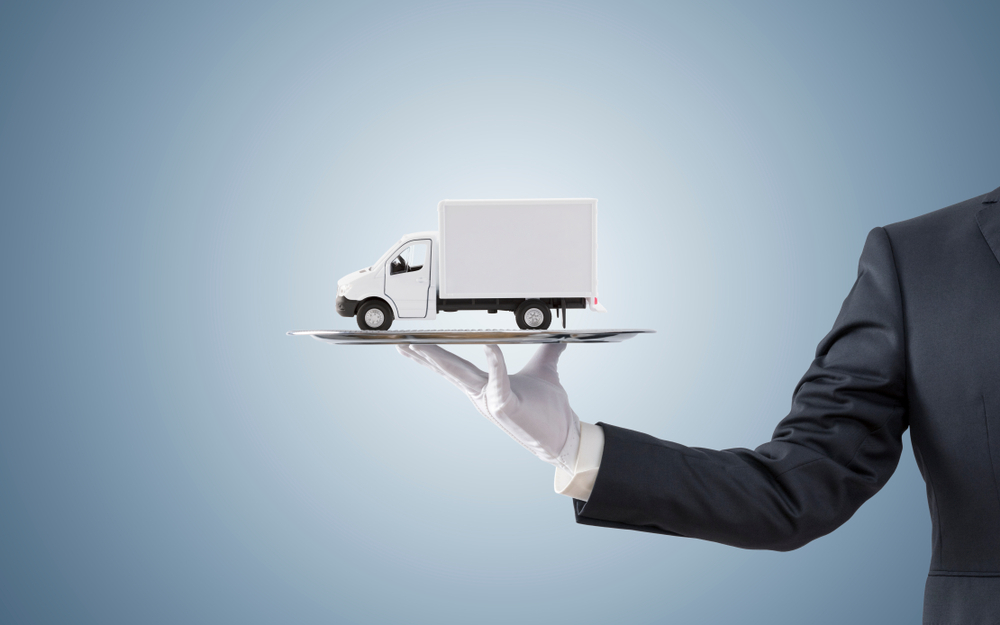 business man offering cargo delivery truck